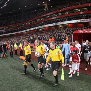 The match officials lead the team out onto the picth before the match. Arsenal 4 The match officials lead the team out onto the picth before the match. Arsenal 4