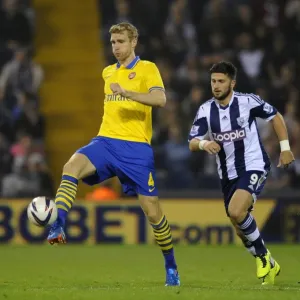 Per Mertesacker vs. Shane Long: A Battle for Control in the Capital One Cup (West Bromwich Albion vs. Arsenal, 2013-14) Per Mertesacker vs. Shane Long: A Battle for Control in the Capital One Cup (West Bromwich Albion vs. Arsenal, 2013-14)