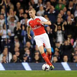 Per Mertesacker's Intense Focus: Arsenal vs. Tottenham Capital One Cup Showdown