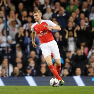 Per Mertesacker's Intense Focus: Arsenal vs. Tottenham Capital One Cup Showdown Per Mertesacker's Intense Focus: Arsenal vs. Tottenham Capital One Cup Showdown