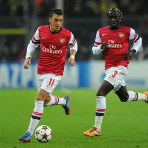Mesut Ozil and Bacary Sagna of Arsenal Facing Off Against Borussia Dortmund in the 2013-14 UEFA Champions League
