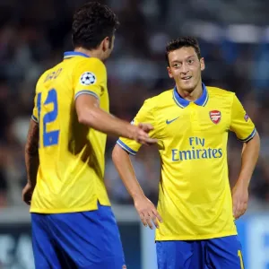 Mesut Ozil and Olivier Giroud: Arsenal's Dynamic Duo in Action against Olympique de Marseille, UEFA Champions League, 2013 Mesut Ozil and Olivier Giroud: Arsenal's Dynamic Duo in Action against Olympique de Marseille, UEFA Champions League, 2013