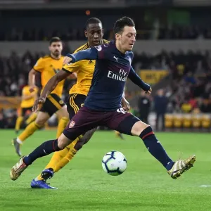 Mesut Ozil Under Pressure: Willy Boly Closes In during Wolverhampton Wanderers vs. Arsenal FC, Premier League 2018-19 Mesut Ozil Under Pressure: Willy Boly Closes In during Wolverhampton Wanderers vs. Arsenal FC, Premier League 2018-19