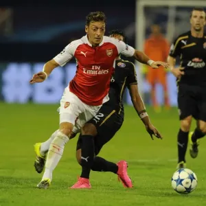 Mesut Ozil Scores Past Dinamo Zagreb's Defense in 2015-16 UEFA Champions League: Arsenal's Star Playmaker in Action