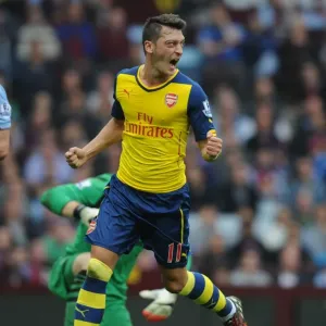 Mesut Ozil's Signature Moment: Scoring First for Arsenal Against Aston Villa in the Premier League 2014-15
