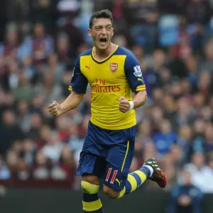 Mesut Ozil's Triumph: Scoring First Goal for Arsenal Against Aston Villa in Premier League 2014-15