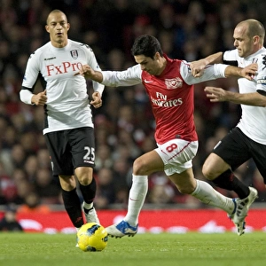 Mikel Arteta of Arsenal breaks past Danny Murphy of Fulham during the Barclays Premier League match between Arsenal and Fulham at Emirates Stadium on November 26, 2011 in London, England. Credit; Arsenal