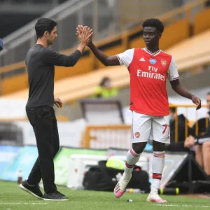Mikel Arteta and Bukayo Saka: A High-Fiving Moment at Wolverhampton Wanderers vs Arsenal FC (Premier League 2019-20)