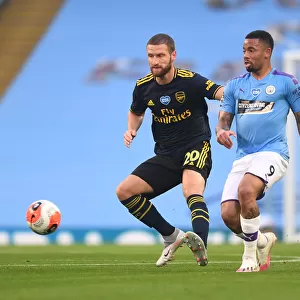 Mustafi Closes In: Manchester City vs. Arsenal FC - Premier League Showdown