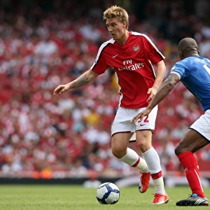 Nicklas Bendtner (Arsenal) Sylvain Distin (Portsmouth)