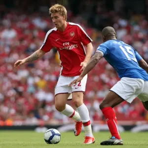 Nicklas Bendtner (Arsenal) Sylvain Distin (Portsmouth) Nicklas Bendtner (Arsenal) Sylvain Distin (Portsmouth)