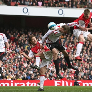 Nicklas Bendtner jumps above Peter Crouch to head in the Arsenal goal