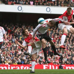 Nicklas Bendtner jumps above Peter Crouch to head in the Arsenal goal