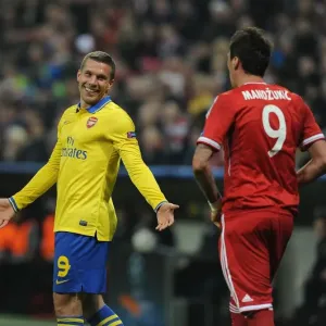 Podolski and Mandzukic Share a Laugh: Bayern Munich vs. Arsenal, UEFA Champions League 2014 Podolski and Mandzukic Share a Laugh: Bayern Munich vs. Arsenal, UEFA Champions League 2014