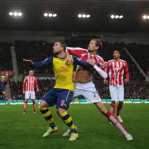Podolski vs Crouch: Intense Battle at Britannia Stadium - Stoke City vs Arsenal, Premier League 2014-15 Podolski vs Crouch: Intense Battle at Britannia Stadium - Stoke City vs Arsenal, Premier League 2014-15