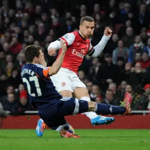 Podolski vs. Riether: Intense Moment at Arsenal v Fulham, Premier League Podolski vs. Riether: Intense Moment at Arsenal v Fulham, Premier League