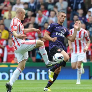Podolski vs. Wilkinson: Intense Clash in Stoke City vs. Arsenal (2012-13) Podolski vs. Wilkinson: Intense Clash in Stoke City vs. Arsenal (2012-13)