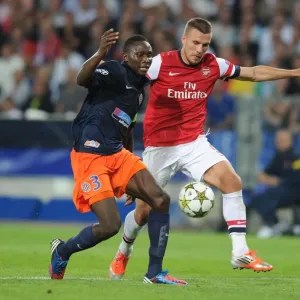 Podolski vs Yanga-Mbiwa: Battle in the UEFA Champions League Podolski vs Yanga-Mbiwa: Battle in the UEFA Champions League