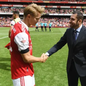 Print of Martin Odegaard lifting Emirates Cup
