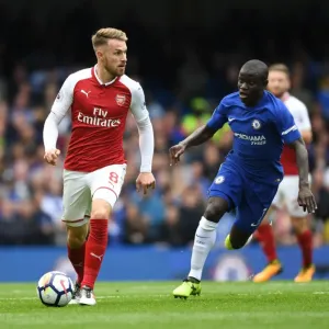 Ramsey Outmaneuvers Kante: Intense Battle between Arsenal's Aaron Ramsey and Chelsea's N'Golo Kante during the Premier League Match Ramsey Outmaneuvers Kante: Intense Battle between Arsenal's Aaron Ramsey and Chelsea's N'Golo Kante during the Premier League Match