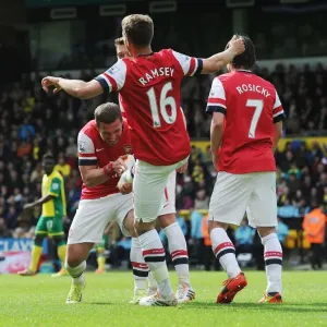 Ramsey and Podolski Celebrate Arsenal's First Goal Against Norwich City (2013-14)