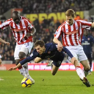Ramsey's Brilliant Performance: Arsenal Overpower Stoke's Shawcross and Faye (3-1)