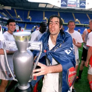Robert Pires (Arsenal) celebrates winning the League