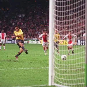 Robert Pires shoots past Ajax goalkeeper Hans Vonk to score the 2nd Arsenal goal from the penalty sp Robert Pires shoots past Ajax goalkeeper Hans Vonk to score the 2nd Arsenal goal from the penalty sp