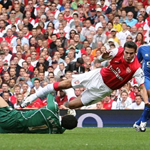 Robin van Persie (Arsenal) is fouled by David James (Portsmouth) for Arsenals penalty