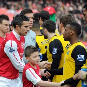 Robin van Persie (Arsenal) shakes hands with Junior Hoilett (Rovers) before the match