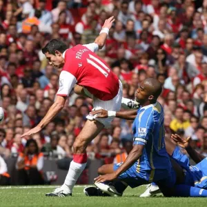 Robin van Persie (Arsenal) Sylvian Distan and Sulley Muntari (Portsmouth) Robin van Persie (Arsenal) Sylvian Distan and Sulley Muntari (Portsmouth)