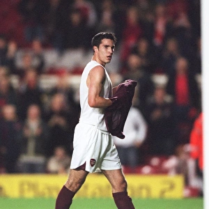 Robin van Persie (Arsenal) takes of his shirt to throw it into the crowd