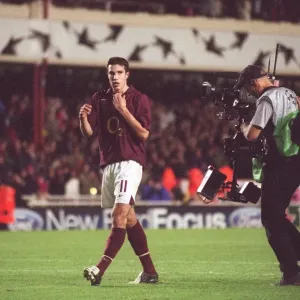 Robin van Persie (Arsenal) walks over to the fans followed by a TV Cameraman Robin van Persie (Arsenal) walks over to the fans followed by a TV Cameraman