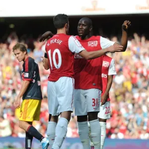 Robin van Persie celebrates scoring Arsenals goal with Benik Afobe