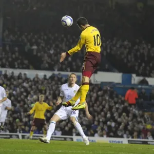 Robin van Persie heads past Leeds goalkeeper Kasper Schmeichel to score the 3rd Arsenal goal