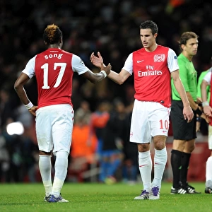 Robin van Persie shakes hands with Alex Song (Arsenal) at the end of the match