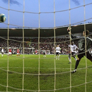 Robin van Persie shoots past Derby goalkeeper Roy Carroll to score the 2nd Arsenal goal