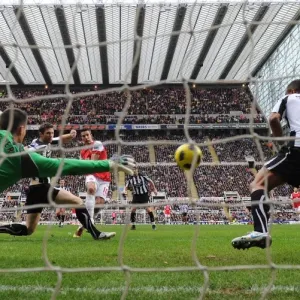 Robin van Persie shoots past Newcastle goalkeeper Steve Harper to score the 3rd Arsenal goal