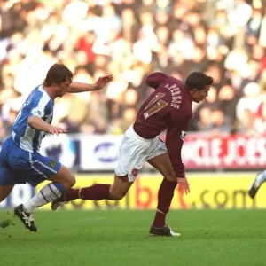 Robin van Persie spins away from Arjen Dezeeuw (Wigan) on his way to scoring Arsenals 1st goal