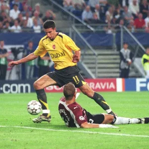 Robin van Persie is tripped by Hamburg goalkeeper Sasha Kirschstein for the Arsenal penalty