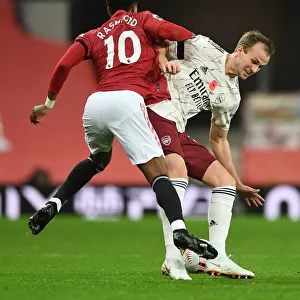 Rousing Rivalry: Holding vs. Rashford - A Premier League Battle at Empty Old Trafford (Manchester United vs. Arsenal, 2020-21)