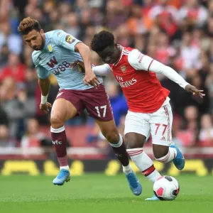 Saka vs Trezeguet: Intense Face-Off in Arsenal's Battle Against Aston Villa