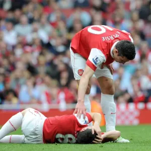 Samir Nasri injured on the floor as Robin van Persie (Arsenal) checks on him