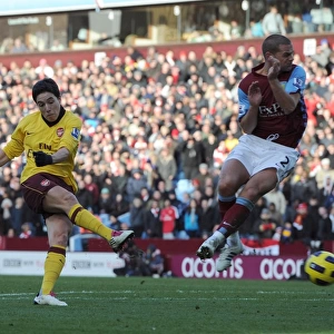 Samir Nasri scores Arsenals 2nd goal under pressure from Luke Young (Villa)