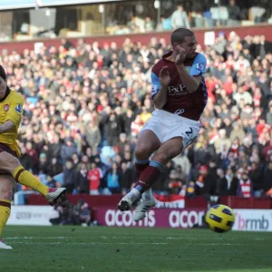 Samir Nasri scores Arsenals 2nd goal under pressure from Luke Young (Villa)