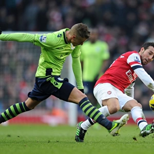 Santi Cazorla vs Joe Bennett: Intense Battle for Ball Possession - Arsenal v Aston Villa (2012-13)