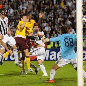 Sebastien Squillaci heads past Partizan goalkeeper Vladimir Stojkovic to score the 3rd Arsenal goal