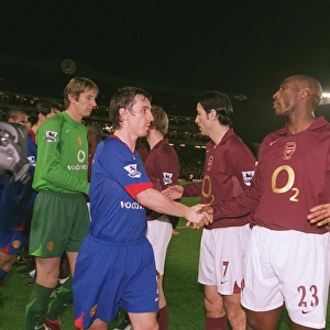 Sol Campbell and Kolo Toure (Arsenal) shake hands with Gary Neville (Man Utd)