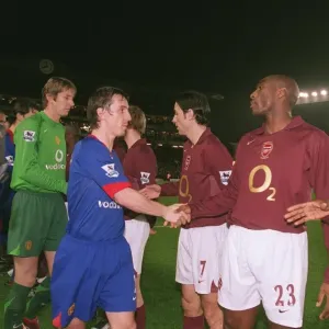 Sol Campbell and Kolo Toure shaking hands with Gary Neville, Print