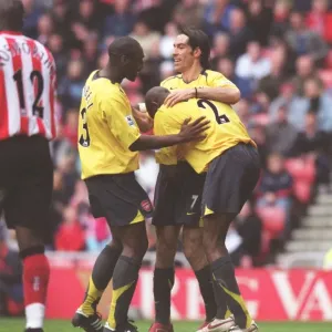 Sol Campbell, Robert Pires and Abou Diaby celebrate a goal in print Sol Campbell, Robert Pires and Abou Diaby celebrate a goal in print